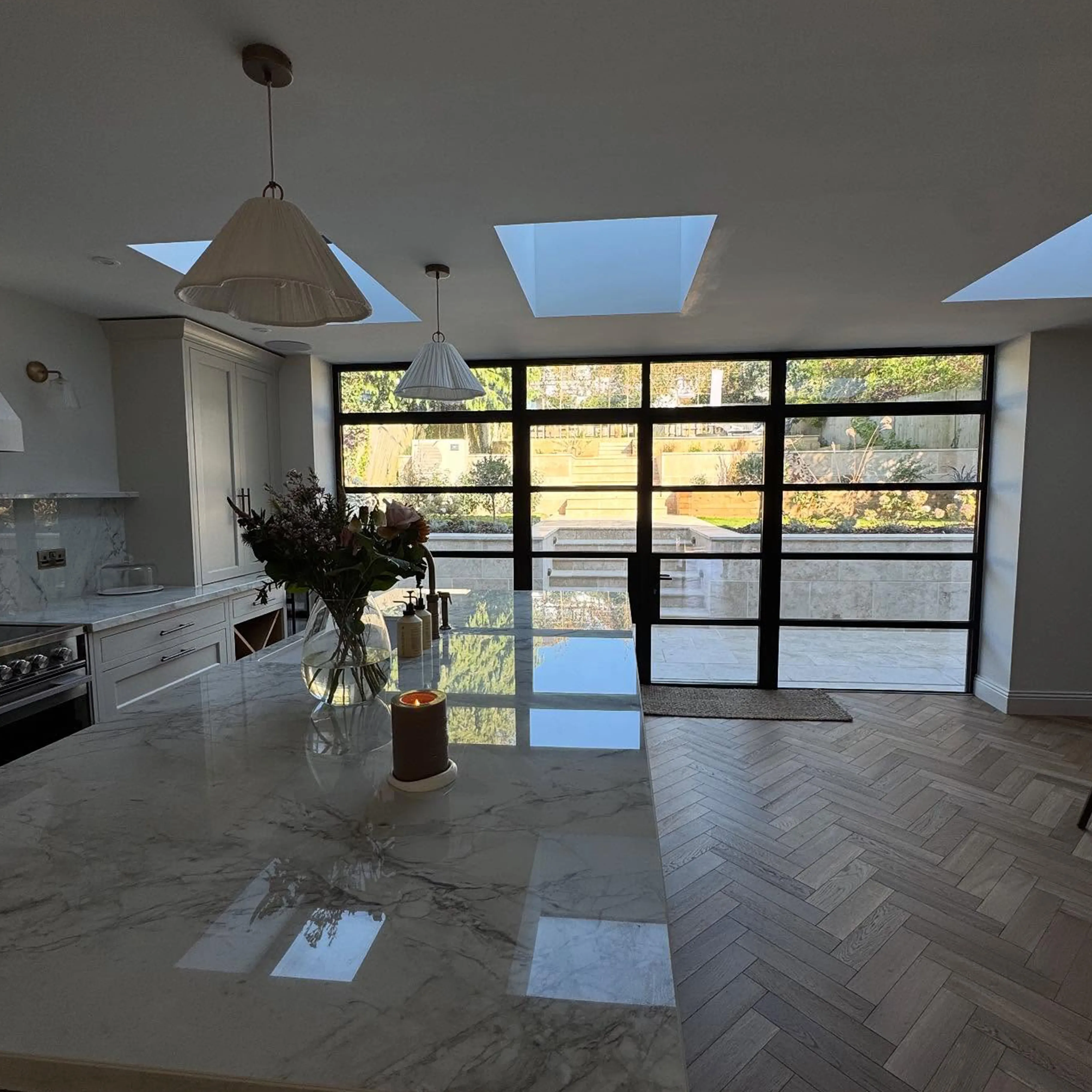 A kitchen with a large marble counter top.