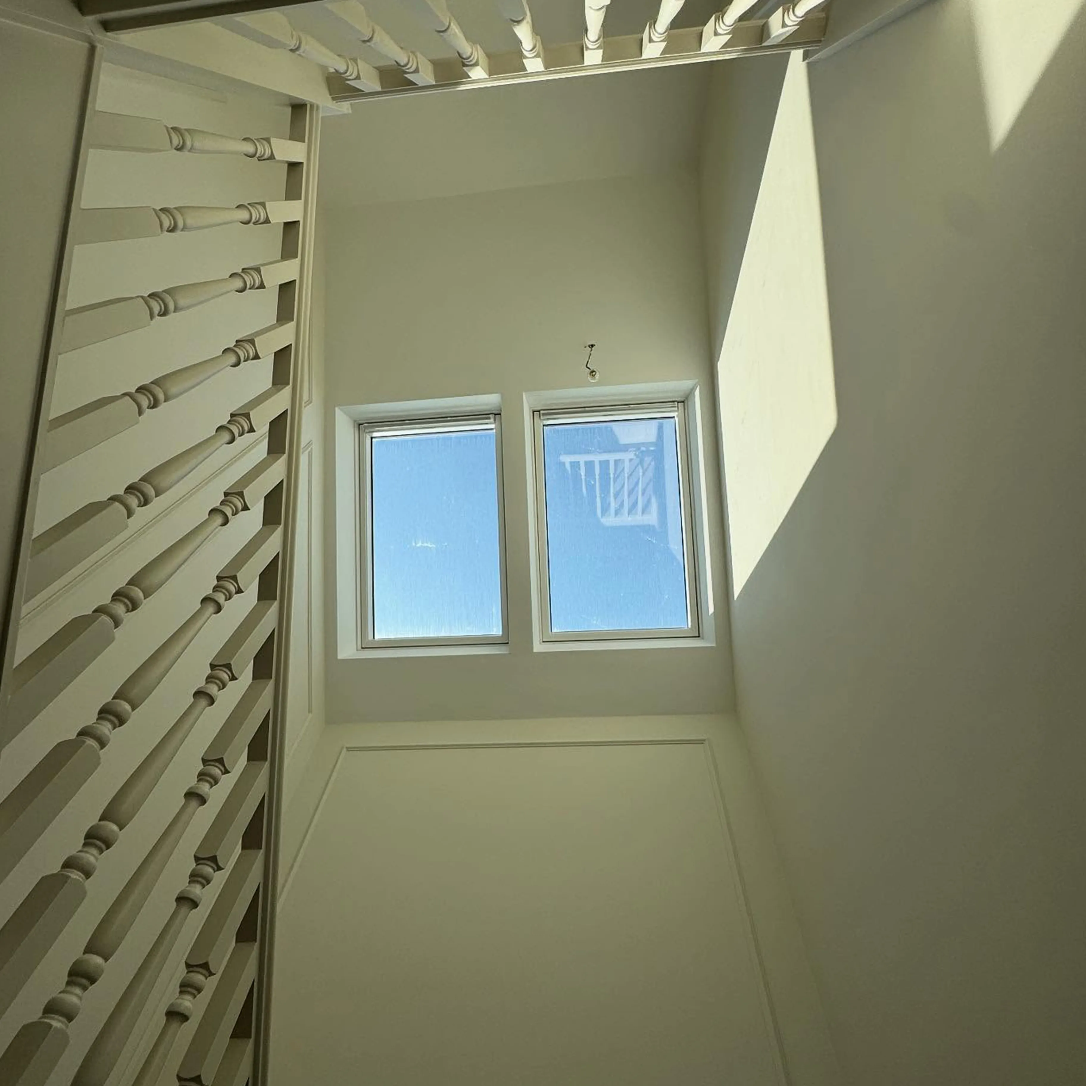 A room with a window and a ladder.