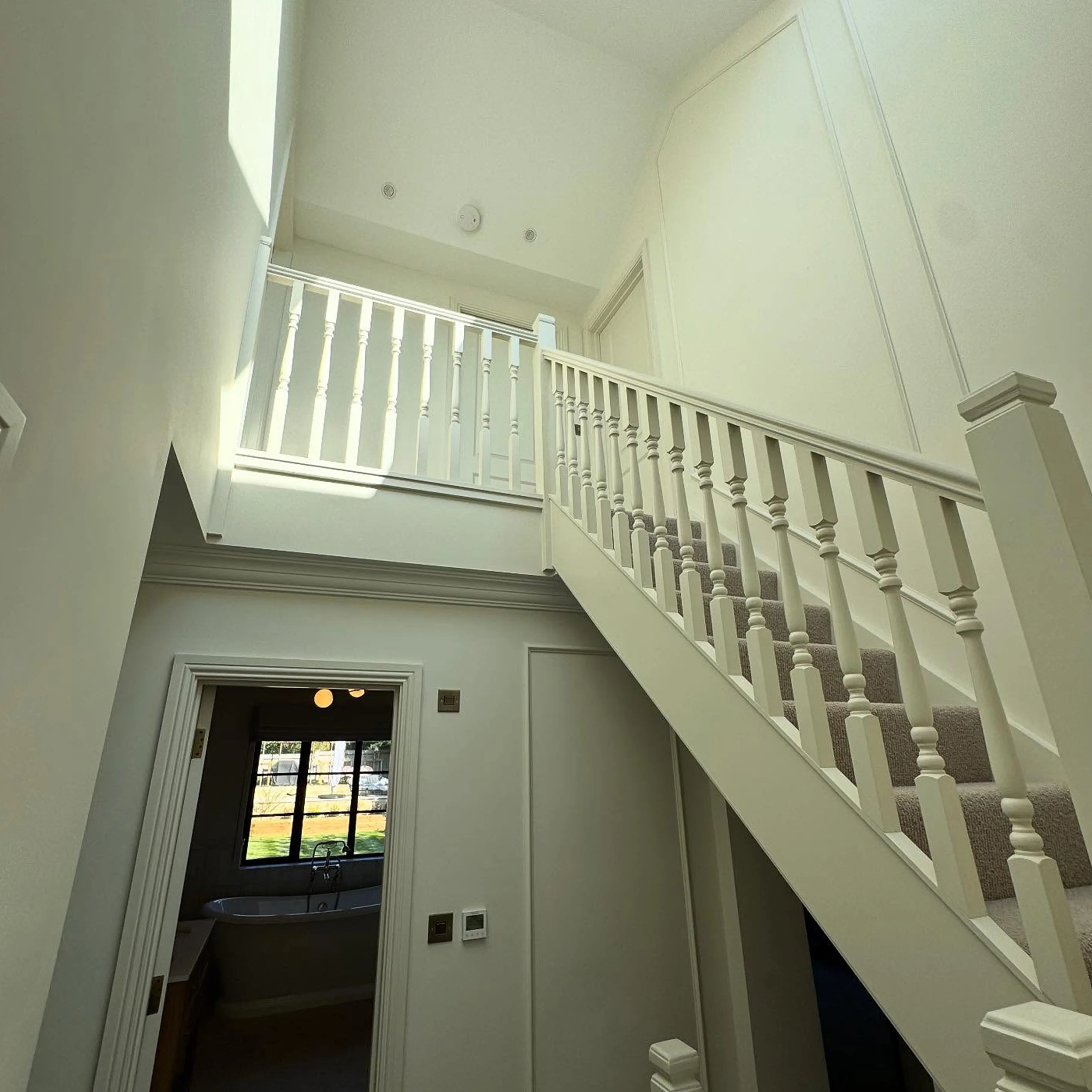 A white staircase leading to a second story.